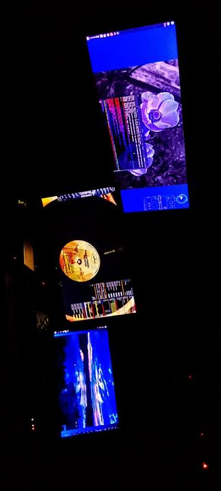 The photograph shot in total absolute darkness shows a collage of four IPS LED panels, each displaying different content. The top screen features a blue background with a flower image and a text editor window Bash shells tabbed, with code. The middle screen displays a vinyl record label of Kraftwerk Autobahn, with a colorful design and a digital audio workstation interface. The bottom screen shows a blue-toned image with abstract patterns, possibly a visualizer or a live performance. The screens are arranged vertically, with the top screen at the top, the middle screen in the center, and the bottom screen at the bottom. The background is dark, emphasizing the screens' content.

 Ovis2-8B

🌱 Energy used: 0.156 Wh