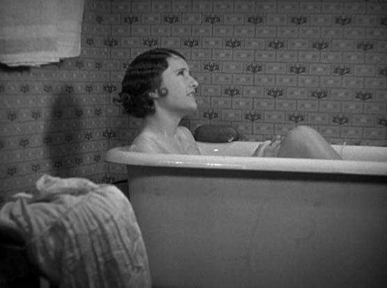 an image from the film, a young woman with short flapper-type wavy hair is in a bathtub