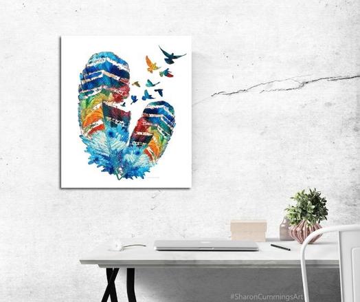 Two colorful feathers with birds flying out by artist Sharon Cummings.