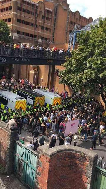 3 police vans and a row of police in high Viz forming a line to separate a far right anti immigration group and a very much larger counter protest in Bristol UK.