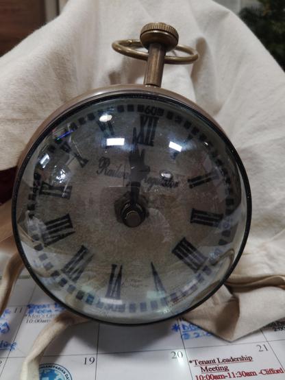 Globe shaped clock front with the words Railway Regulator on the dial