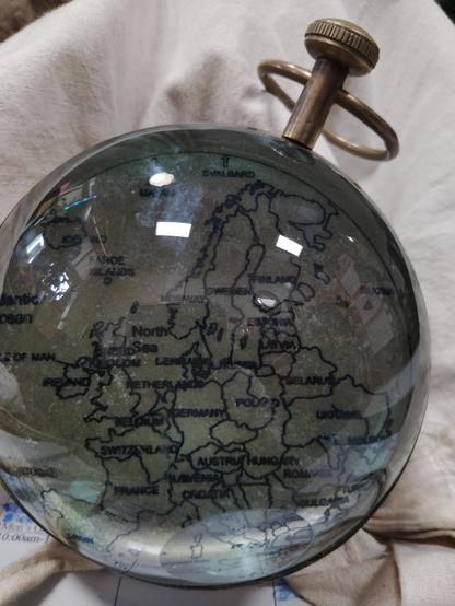 Rear of globe shaped clock showing map of europe.