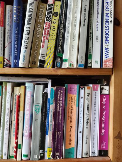 The bookshelf above my desk, crammed with books on Lisp.