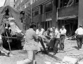 Aftermath of Mitsubishi bombing, with rescue workers.