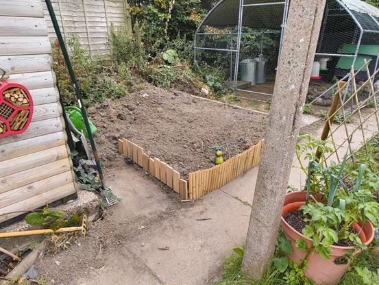 Raised earth bed during construction, showing partly finished edge.
