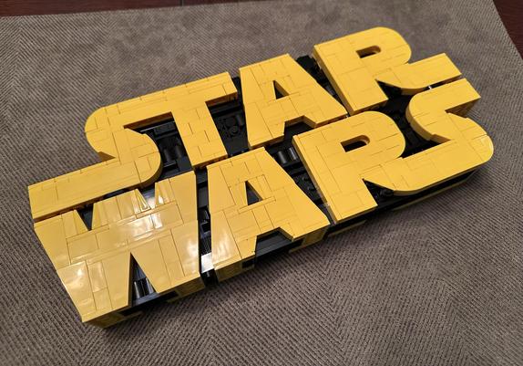 Completed LEGO Star Wars logo build laying down on a table.