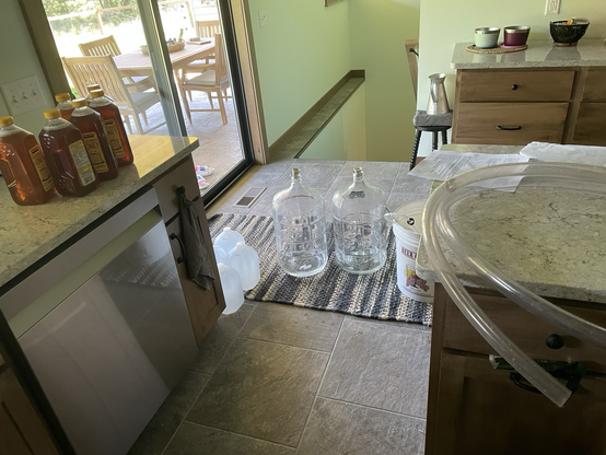 Empty carboys, honey on the kitchen counter by the brewing equipment