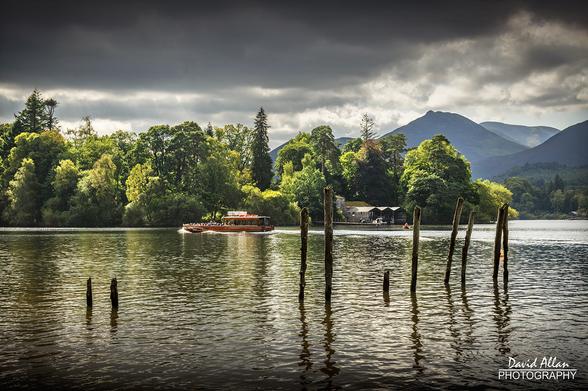 September arrives and for the avoidance of doubt, it is still the season of summer in the Northern Hemisphere. This is Derwent Water at Keswick in England's Lake District where a pleasure boat makes its way across the lake against a background landscape of tree-lined shores and distant Cumbrian fells.