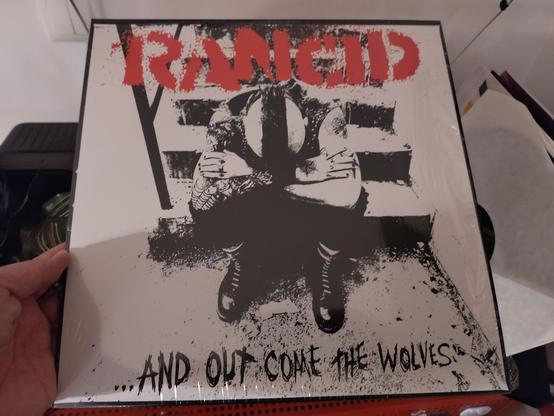 cover, saying Rancid ...and out come the wolves. there is a guy sitting, with a mohawk and the head down in his hands