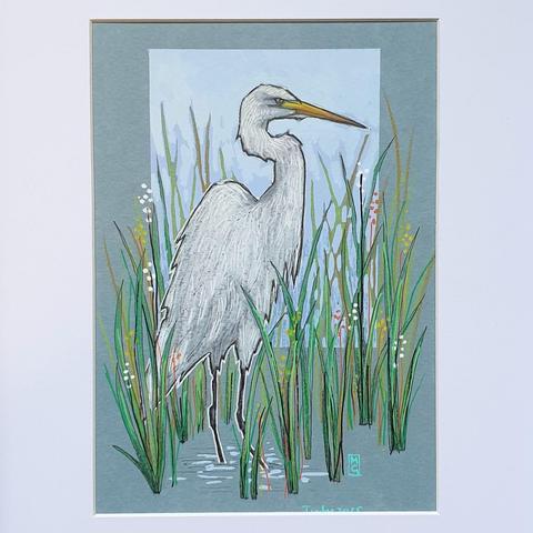 A small drawing of a Great White Egret bird standing in water with long grasses. A white heron like bird with black feet and legs and a yellow beak. The drawing is on light blue pastel paper.
What was once a very rare bird in Britain and Ireland, the Great White Egret can now be seen throughout the year, often in association with other herons.
An original art work, sold unframed
Colour pencil and mixed media on acid free toned artist paper
5 by 7 inches (12.7 by 17.8 cm).