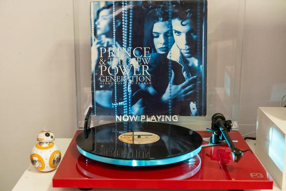 Prince & The New Power Generation - Diamonds and Pearls LP on a red turntable with its cover on display