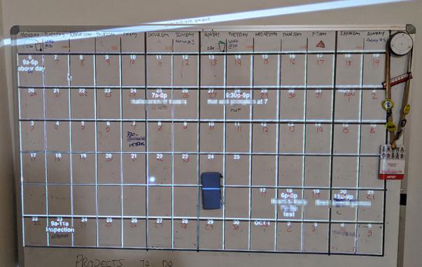 Whiteboard-based handwritten calendar with duplicate calendar projected over it