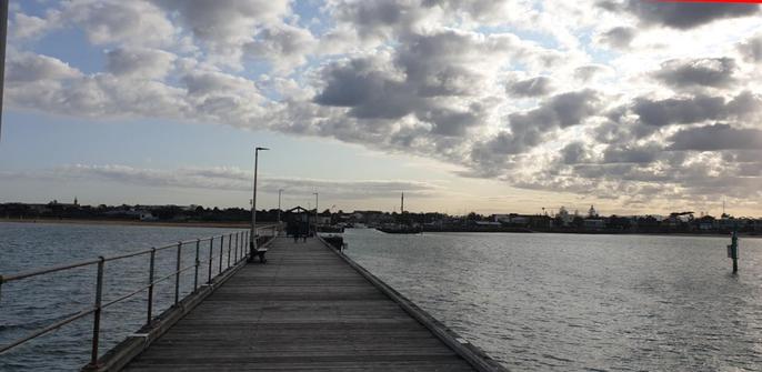 Photo taken from the end of Mordialloc pier looking back toward the shore taken at 08:00AM . A bit dark as at this point the sun was still behind the clouds.