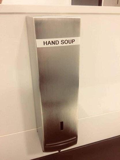 Bathroom soap dispenser. The label on it says "Hand Soup."