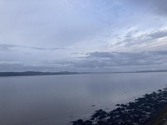 View across Tay firth on a grey morning seaweed exposed on the low tide, quiet reflections of grey on grey