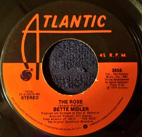 The 45 RPM vinyl record of "The Rose" by Bette Midler on Atlantic Records from 1979.