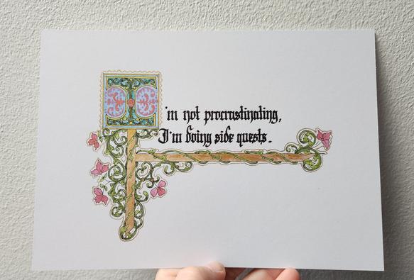 'I'm not procrastinating, I'm doing side quests.' calligraphed in black ink blackletter script with an illuminated first 'I', decorated with green vine and pink-red flowers twirling around gold bars