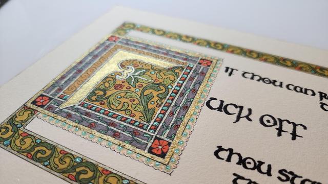 Angled close up on the F, there's lots of shiny metallic ink and paint