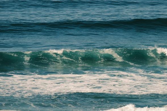 a photo of the ocean in which a cresting wave creates horizontal layers in the frame.