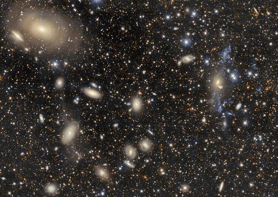 The galaxy cluster Abell 3754 is captured here by the 570-megapixel Department of Energy-fabricated Dark Energy Camera (DECam) on the Víctor M. Blanco 4-meter Telescope, one of around 40 telescopes at the U.S. National Science Foundation Cerro Tololo Inter-American Observatory (CTIO) in Chile, a Program of NSF NOIRLab. 

Located about 200 million light-years away, Abell 3754 is a gravitationally-bound group of hundreds of galaxies. Galaxy clusters are the second-largest-scale structures known in the Universe, but even at their massive scale these galaxies are never all that far from each other. In the top left, the large galaxy IC 4329, surrounded by rings of light, shows evidence of a past cosmic collision. The spread-out fragments of illuminated blue and white gas on the right side of the image are evidence of a similar clash with the galaxy NGC 5291 (yellow color). If you look closely, you can see more evidence of gravitationally interacting galaxies.