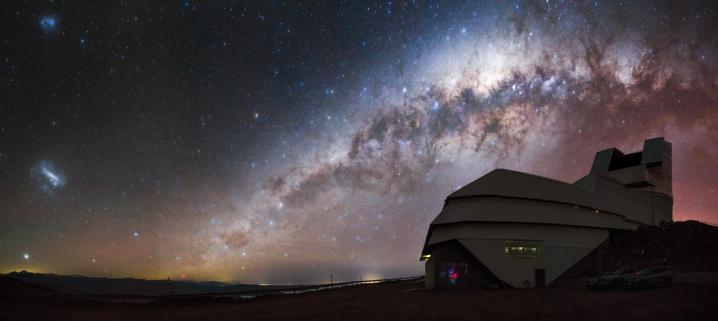 NSF–DOE Vera C. Rubin Observatory in Chile sits beneath a night sky rich with cosmic detail. The Milky Way arcs overhead while the Large and Small Magellanic Clouds glow nearby.