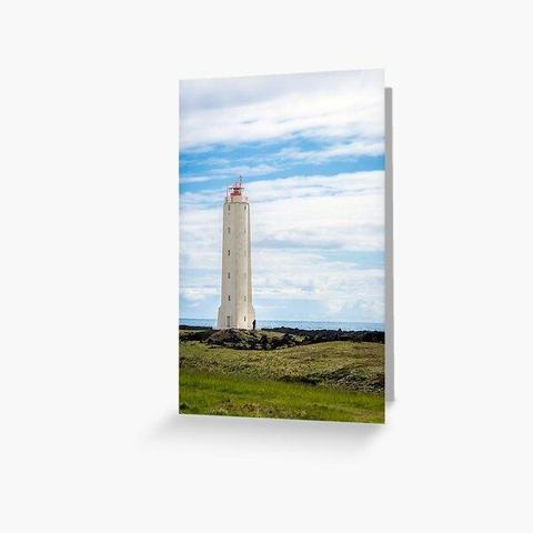 A tall rocket-shaped lighthouse stands on a rocky coastal Iceland landscape. Fluffy clouds fill the sky, giving a serene backdrop to the scene. Photography by Debra Martz
Image printed on a greeting card. A tall rocket-shaped lighthouse stands on a rocky coastal Iceland landscape. Fluffy clouds fill the sky, giving a serene backdrop to the scene. Photography by Debra Martz
Image printed on a greeting card.