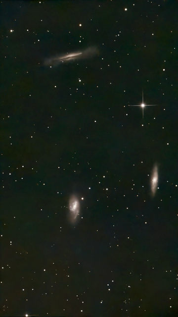 M65 / M66 / NGC 3628 Galaxies - s50 telescope processed image with Moon and Sky Light Filter.  The Leo Triplet is a famous group of three gravitationally-interacting spiral galaxies approximately 35 million light-years away. NGC 3628 (The Hamburger Galaxy) is seen perfectly edge-on.