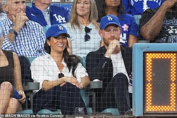 Meghan sat court-side at a World Series Baseball game with Prince Harry opting for an effortlessly chic ensemble of a crisp white Givenchy shirt, previously worn at the Endeavour Fund Awards, Veronica Beard jeans and a baseball hat Meghan sat court-side at a World Series Baseball game with Prince Harry opting for an effortlessly chic ensemble of a crisp white Givenchy shirt, previously worn at the Endeavour Fund Awards, Veronica Beard jeans and a baseball hat
