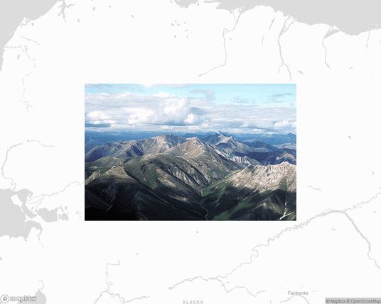 A photo of or from a national park from the linked website, overlaid on a cropped world map where it's located.