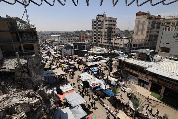 Palestinians gather at a market at the Nuseirat refugee camp in the central Gaza Strip, on May 10, 2025.