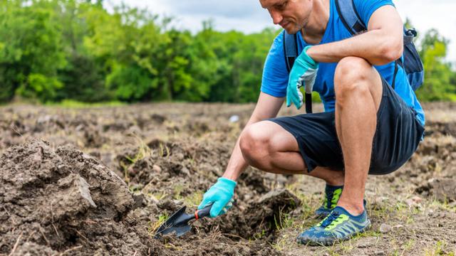 A man digging for diamonds at Crater of Diamonds State Park in 2020.