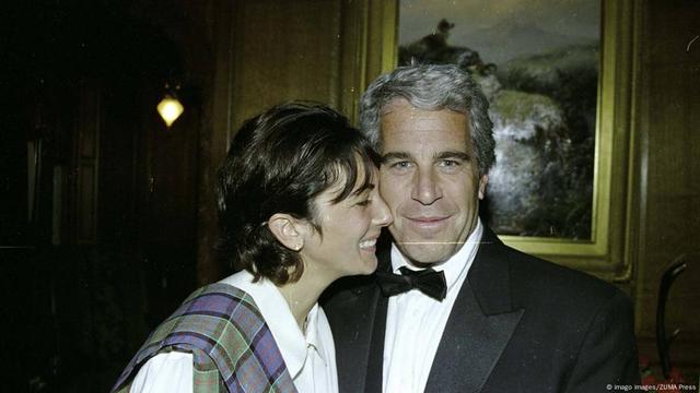 Jeffrey Epstein  in black tie as a smiling Ghislaine Maxwell embraces him