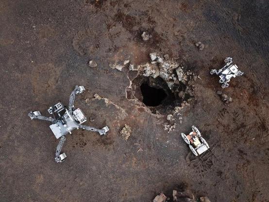 European researchers are developing a three-member team of robots that can cooperatively explore lunar caves. In this image, the robots are being tested on the Spanish volcanic island of Lanzarote. Image Credit: Aerial Skylight Robots/ University of Malaga