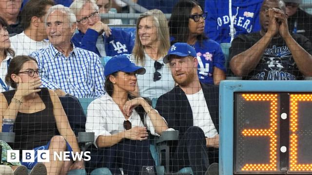 Meghan Markle and Prince Harry wear blue Dodgers baseball caps while seated in the front row during the third inning between the Toronto Blue Jays and the Los Angeles Dodgers during Game 4 of the 2025 MLB World Series at Dodger Stadium. Meghan Markle and Prince Harry wear blue Dodgers baseball caps while seated in the front row during the third inning between the Toronto Blue Jays and the Los Angeles Dodgers during Game 4 of the 2025 MLB World Series at Dodger Stadium.
