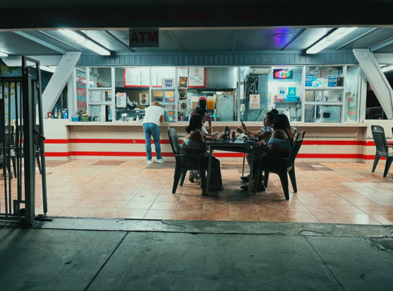 A night scene in front of an outdoor taqueria